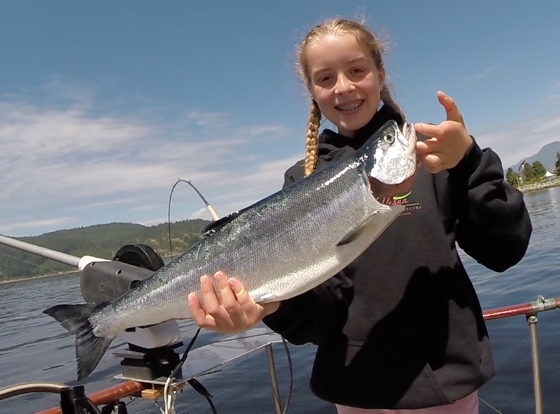 Girl with sockeye on BC fishing charter